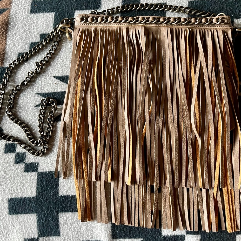 Western style fringe taupe purse.